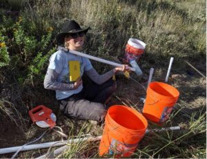 Graduate student Mariel Nelson completes a cluster of piezometers to measure groundwater flow at McDonald.